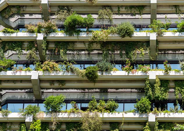 Bepflanzte Balkone und Fassade eines Mehrfamilienhauses © AdobeStock radub85 Bepflanzte Balkone und Fassade eines Mehrfamilienhauses © AdobeStock radub85